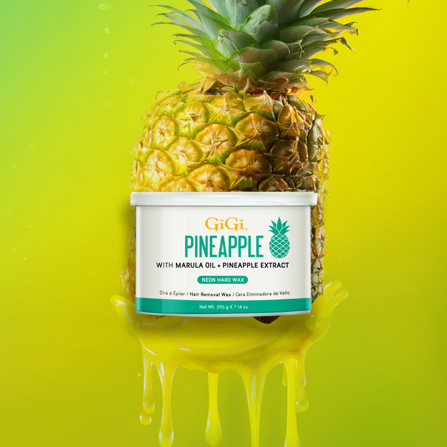 Pineapple-shaped container of GiGi hair removal wax with a pineapple on top against a bright yellow background