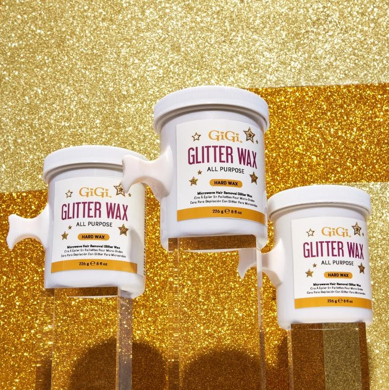 Three containers of GiGi Glitter Wax on a gold glitter background