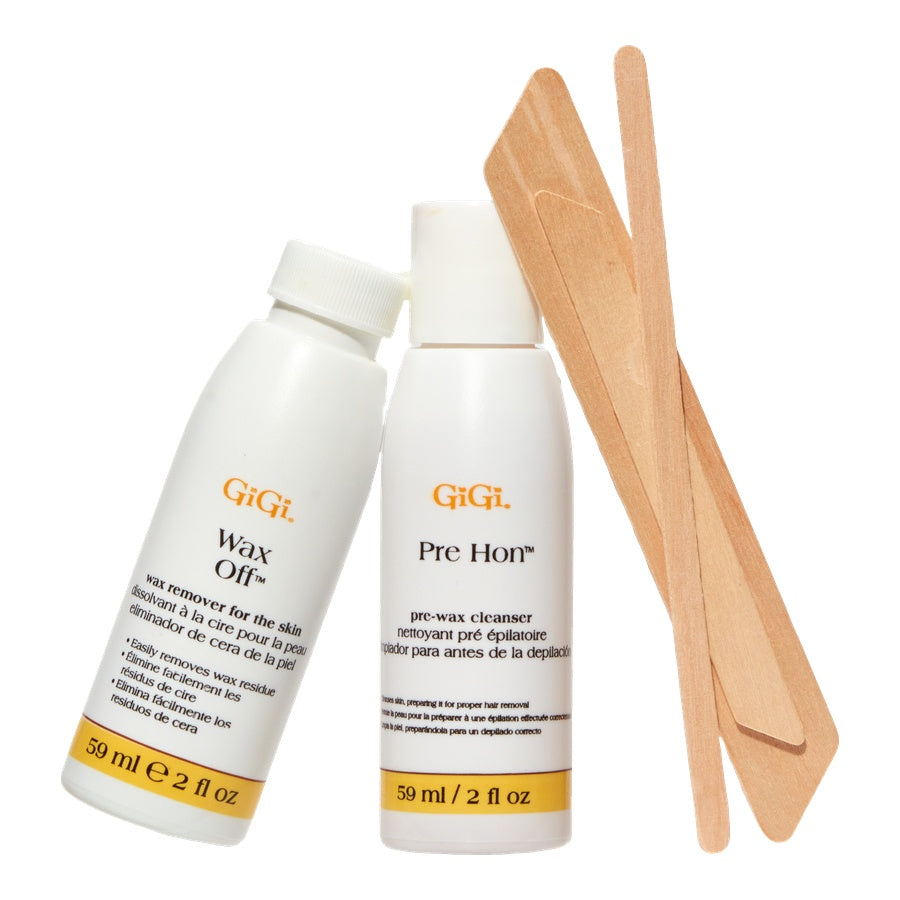 Two bottles of GiGi hair removal products with wooden applicators on a white background