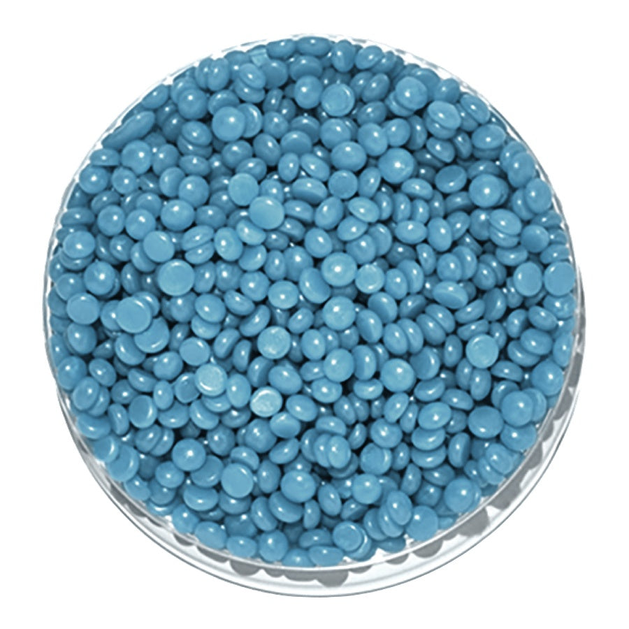 Blue round candies in a clear glass bowl on a white background