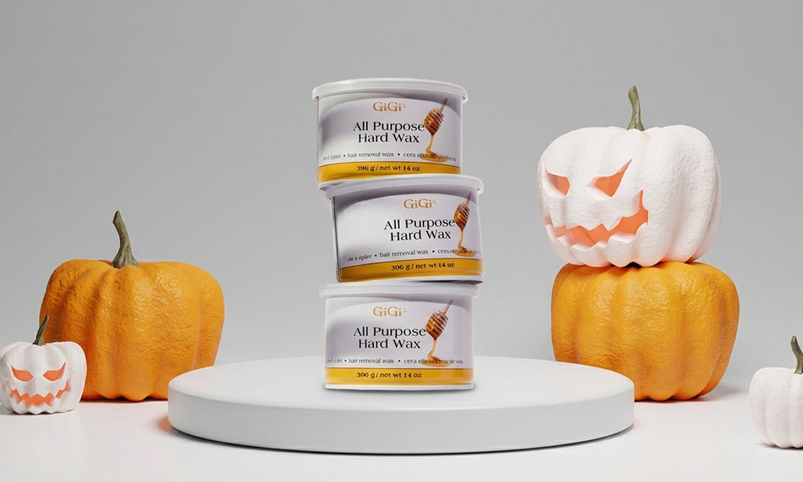 3 wax cans stacked in front of Halloween decorations