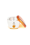 Angled top view of GiGi Honee Wax Warmer with its orange lid propped up against its left side